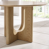 close up image of underneath round oak dining table