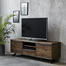 image of dark oak panelled tv unit with tv on top, two drawers on either side of a middle shelf and drawer, pushed against a grey wall adorned with picture frames and a tall plant in the left corner