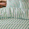 Hettie in green on bed image 2