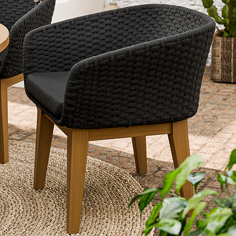 image of black garden dining chair with textured back and plush seat cushion