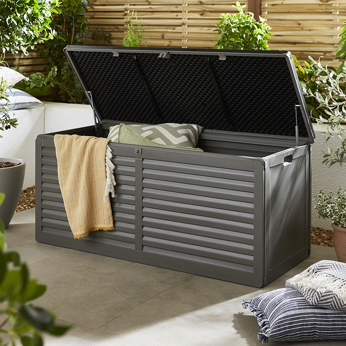 image of large grey storage box with lid open to show storage inside, lid propped open by gas lifts