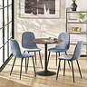 image of four denim blue chenille dining chairs with black metal legs round a black metal table on wooden flooring