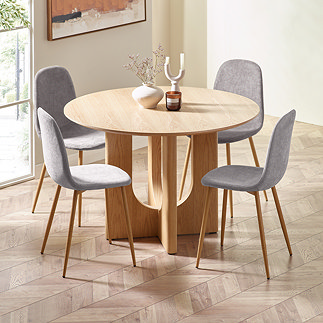 image of four grey chenille chairs round an oak table on wooden chevron flooring