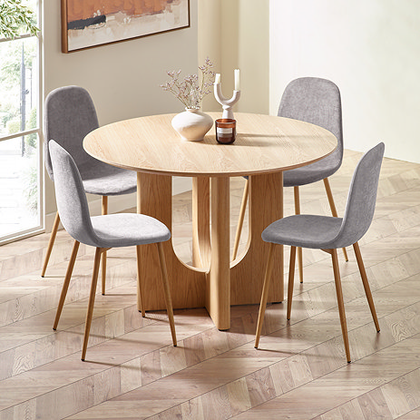image of four grey chenille chairs round an oak table on wooden chevron flooring