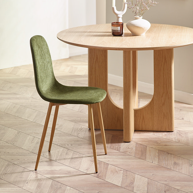 image of singular olive green chenille chair tucked under a light oak table