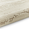 image of marble effect textured cream rug rolled up at end