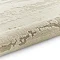 image of marble effect textured cream rug rolled up at end