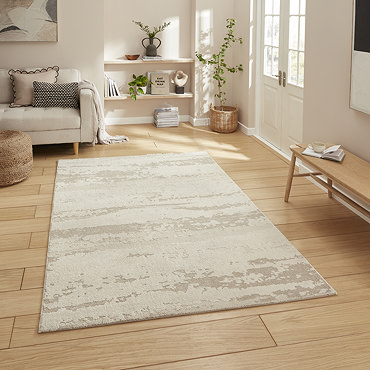angled image of cream contemporary abstract rug on wooden floor