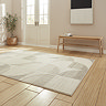 angled image of cream and beige geometric rectangle rug