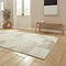 angled image of cream and beige geometric rectangle rug