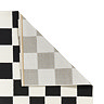image of black and white checkered rug with corner folded over to reveal floor-facing material
