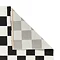 image of black and white checkered rug with corner folded over to reveal floor-facing material