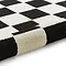 image of black and white checkered rug rolled up at the end