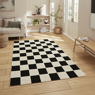 image of black and white checkered rug on light wooden floor