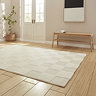 angled image of cream checkered rectangle rug on light wooden flooring