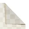image of cream checkered rug folded over at the corner to show floor-facing material underneath