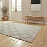 angled image of silver checkered rug on light wooden flooring