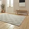 angled image of silver checkered rug on light wooden flooring