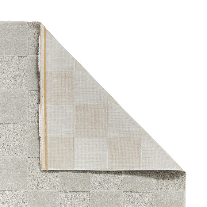 image of silver checkered rug with corner folded over to show floor-facing material