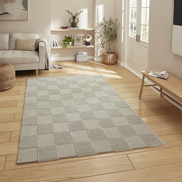 angled image of silver checkered rug on light wooden flooring