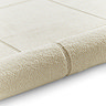 image of cream rug rolled up at the end