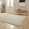 angled image of light brown rug with line detail on light wooden flooring