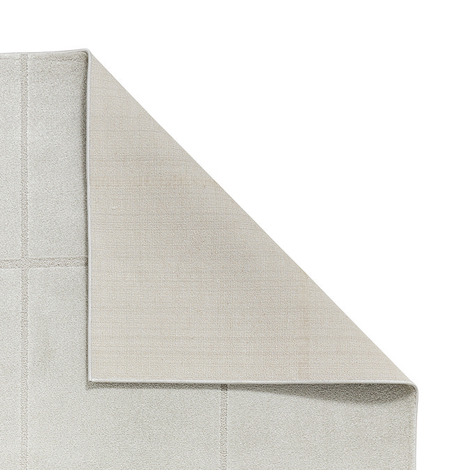 image of silver rug with corner folded over to show floor-facing material underneath