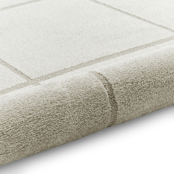 image of silver lined rug rolled up at one end