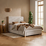 image of light grey velvet bed with front and side storage drawers and sleek headboard, against a light brown wall and with light wood legs on wood floor