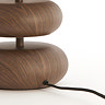 close up image on wooden lamp base with black cable extending from the back