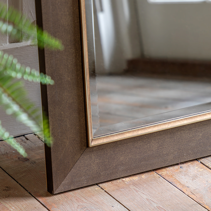 close up image of corner of bronze leaner mirror