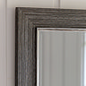 close up on top corner of pewter grey leaner mirror