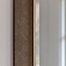 close up on bronze frame of rectangular wall mirror