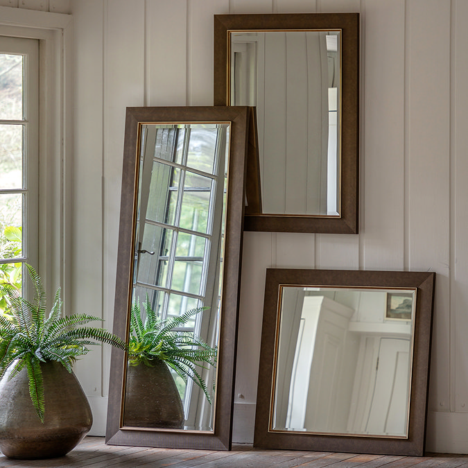 wide shot of collection of mirrors on wall