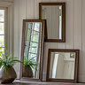 wide shot of collection of mirrors on wall