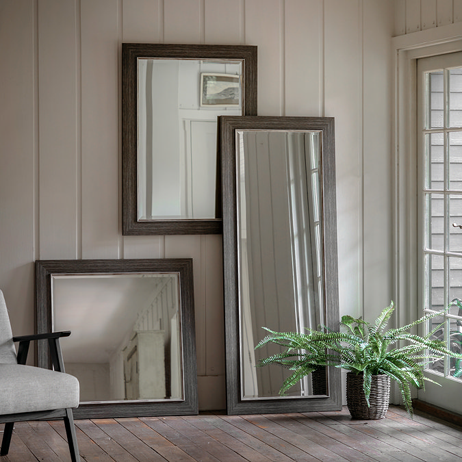 wide image of collection of mirrors on wall
