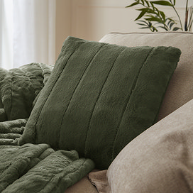 pine green faux fur square cushion on sofa