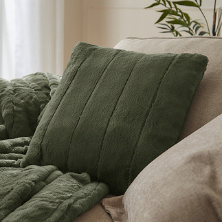 pine green faux fur square cushion on sofa