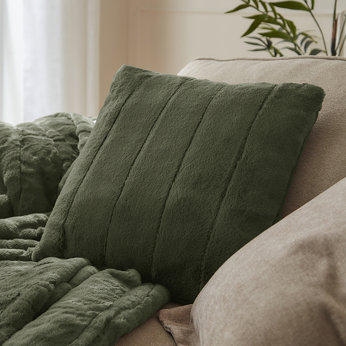 pine green faux fur square cushion on sofa