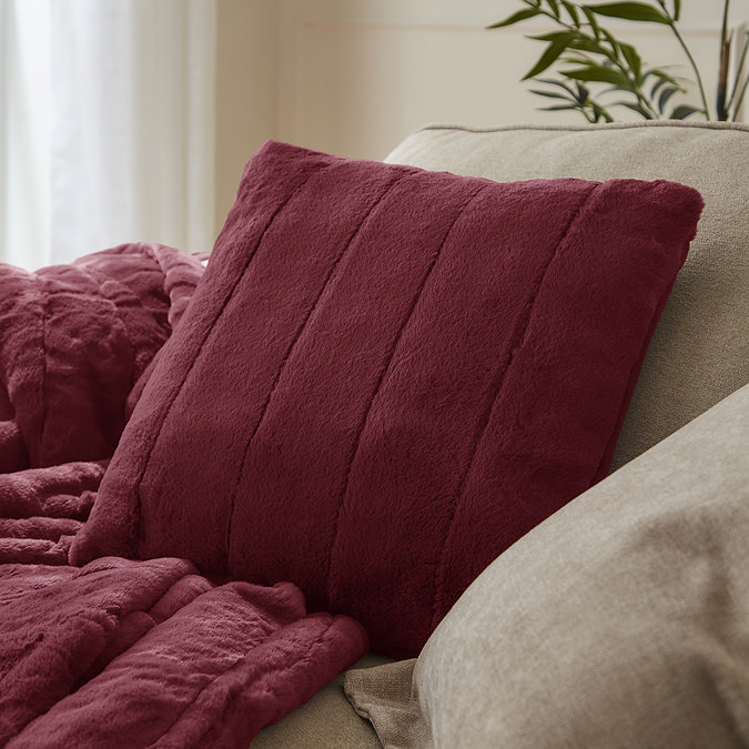 ruby red faux fur cushion on sofa