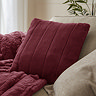 ruby red faux fur cushion on sofa