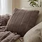taupe coloured square cushion on sofa