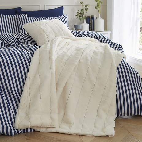 Empress throw cream draped over a bed image 1