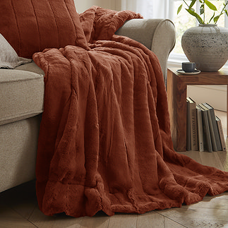 Empress throw in rust draped over a sofa image 1