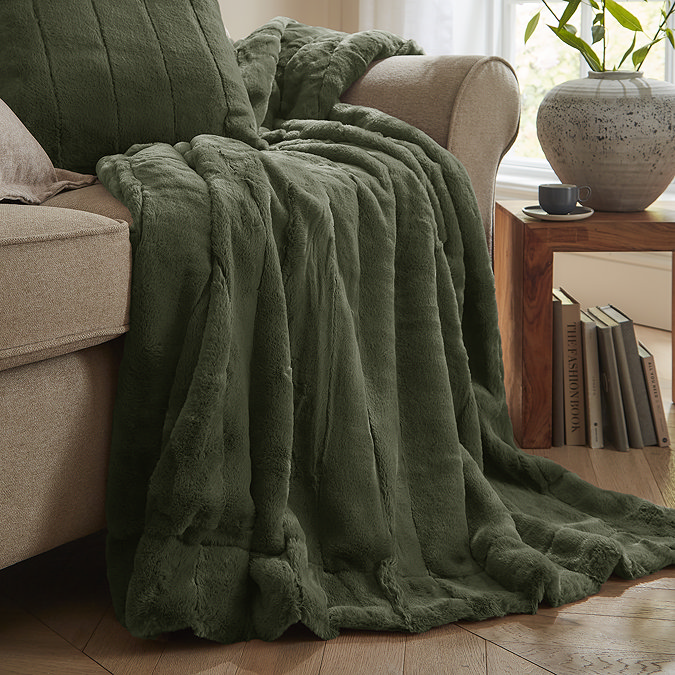 Empress throw in pine draped over the sofa image 1
