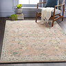 image of soft pinky-orange rug with floral pattern on grey flooring