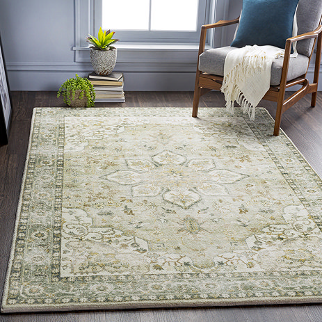 image of sage and yellow floral patterned vintage style rug on grey flooring