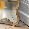 close up image of wavy edged light oak mirror
