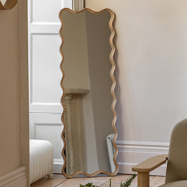 close up image of wavy edge of light oak leaner mirror