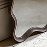 close up image of walnut wiggle shaped frame of floor mirror